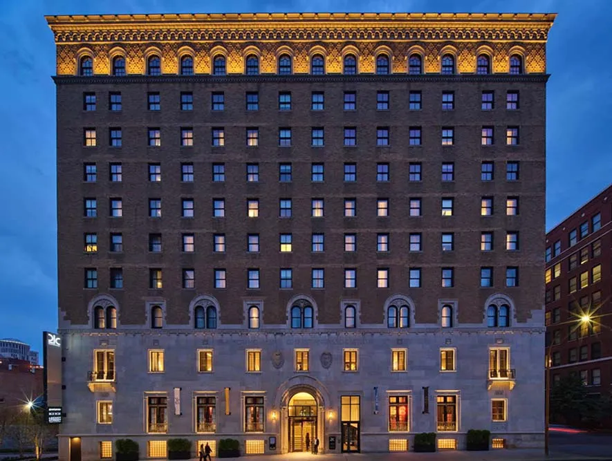 Exterior of 21c Museum Hotel St. Louis at dusk, a converted historic YMCA building in downtown St. Louis