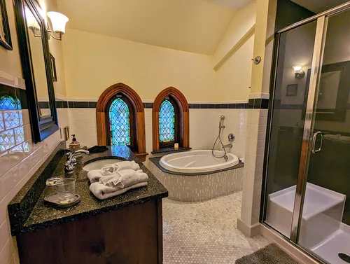 The Hill Suite picture of queen bed with stained glass windows