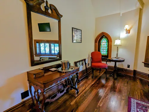 The Hill Suite picture of queen bed with stained glass windows