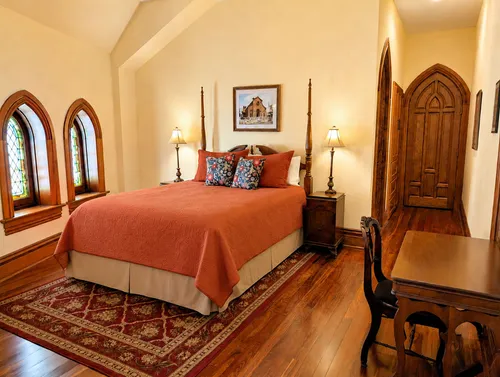 The Hill Suite picture of queen bed with stained glass windows
