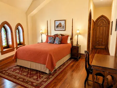 The Hill Suite picture of queen bed with stained glass windows
