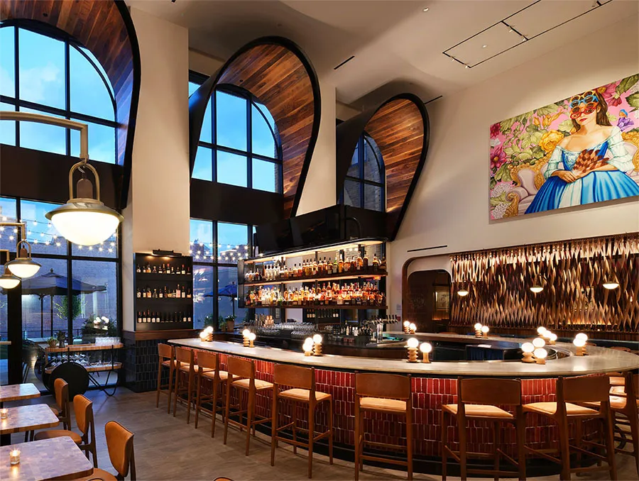 The Idol Wolf bar at 21c Museum Hotel St. Louis with arched windows, dramatic ceiling, and original artwork