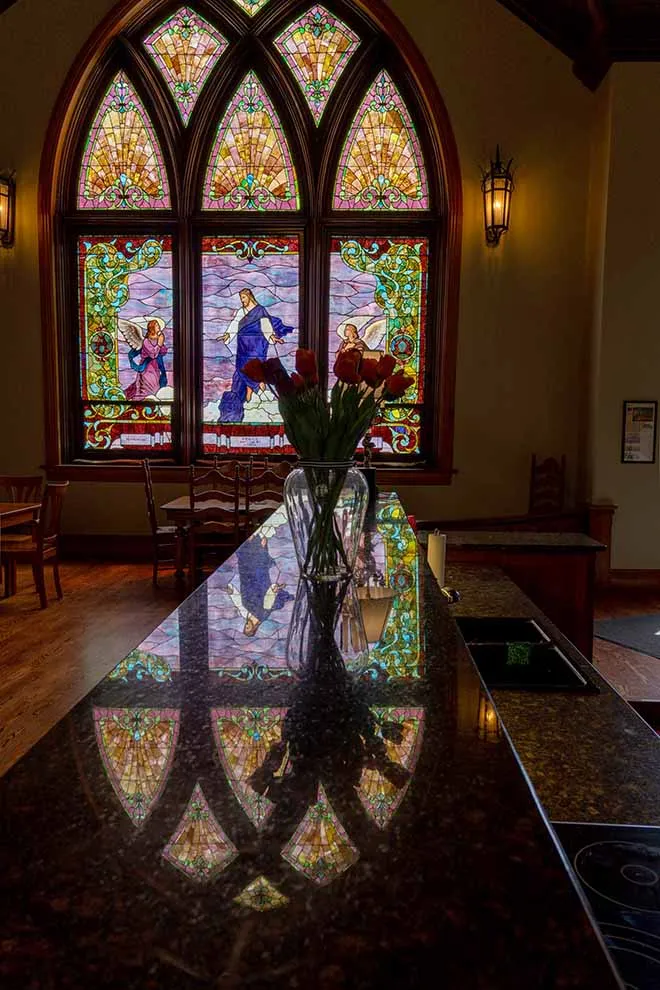 1904 World's Fair stained glass window at Gothic Heights Inn reflecting in the granite countertop