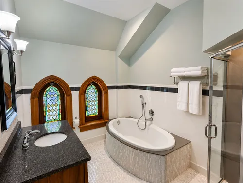 World's Fair en-suite bath with two-person soaking tub and stained glass windows